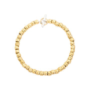 Bracciale Granelli DoDo in argento 925 con anello brisè in oro giallo 18K, design organico e naturale.